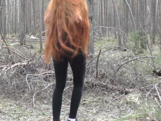 'Redhead girl with long hair walking in the park'