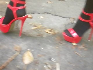 Chick L ambling with splendid crimson high high-heeled slippers.